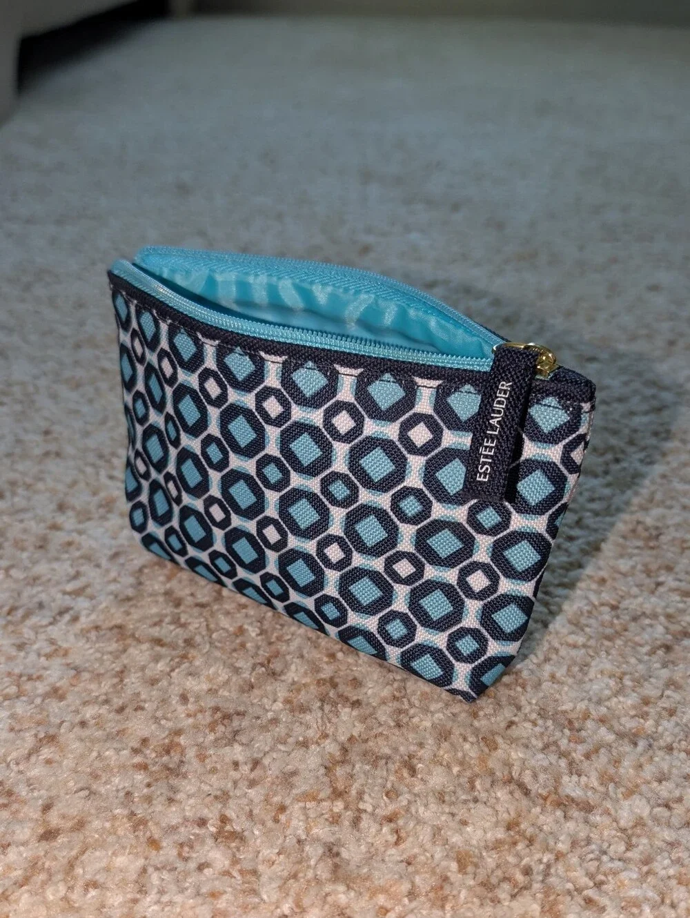 small blue Estee Lauder brand cosmetic pouch